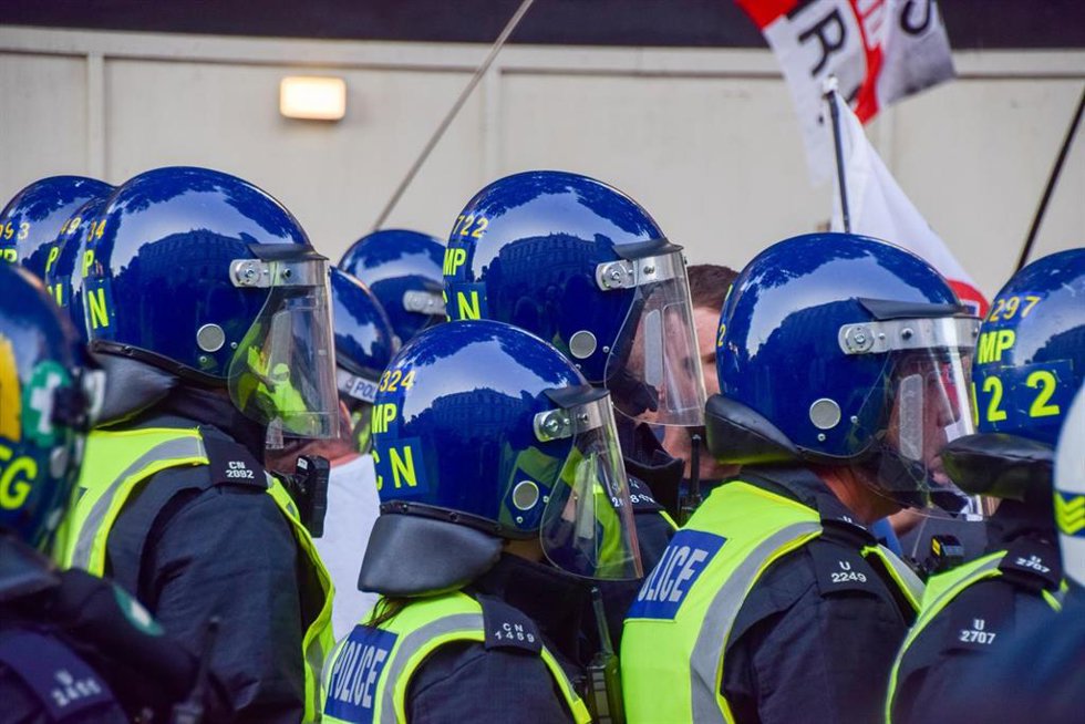 July 31, 2024, London, England, UK: Police in riot gear face off with protesters in Whitehall. Crowds clashed with police officers and threw projectiles in Westminster as protesters turned violent after three young girls were killed in a knife attack in
