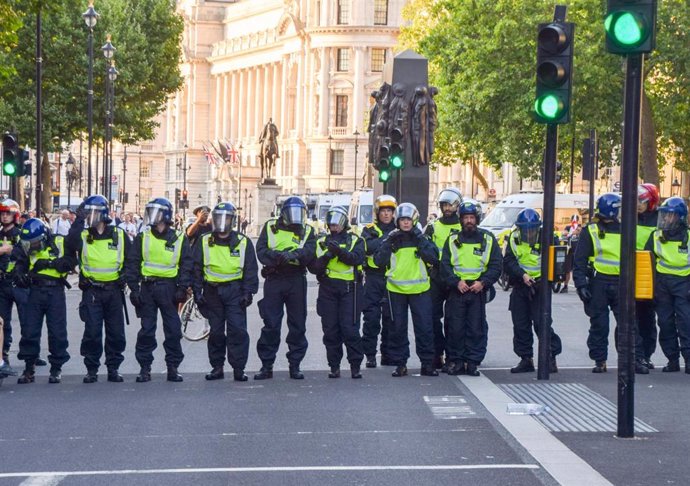 July 31, 2024, London, England, UK: Police in riot gear in Whitehall. Crowds clashed with police officers and threw projectiles in Westminster as protesters turned violent after three young girls were killed in a knife attack in Southport.