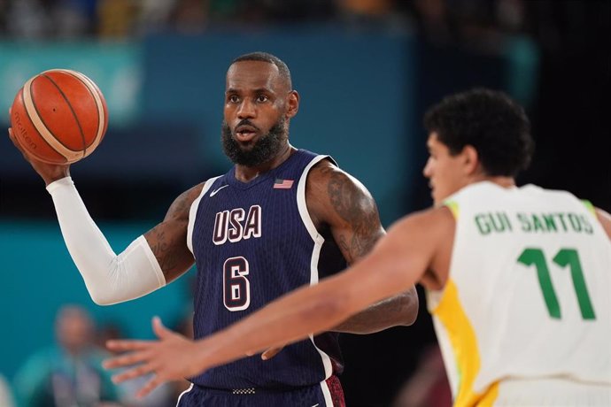 USA's LeBron James (L) and Brazil's Gui Santos in action during the Men's Basketball quarter-final match between Brazil and United States at the Bercy Arena, as part of the the Paris 2024 Olympic Games