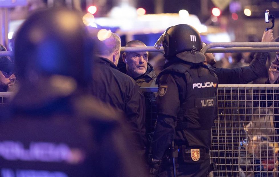 Archivo - Un policía nacional habla con el líder de Desokupa, Daniel Esteve, al Congreso de los Diputados, a 7 de noviembre de 2023, en Madrid (España).
