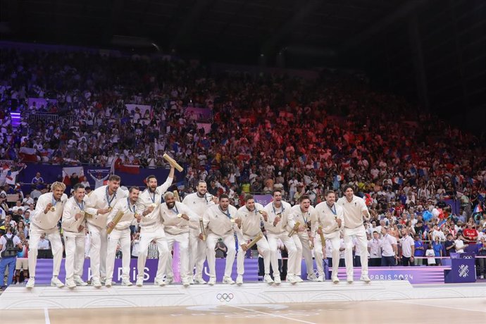 France's Gold medalists volleyball celebrate on the podium during the Volleyball medal ceremony after the Men's Gold Medal Match on Day fifteen of the Olympic Games Paris 2024 at Paris Arena