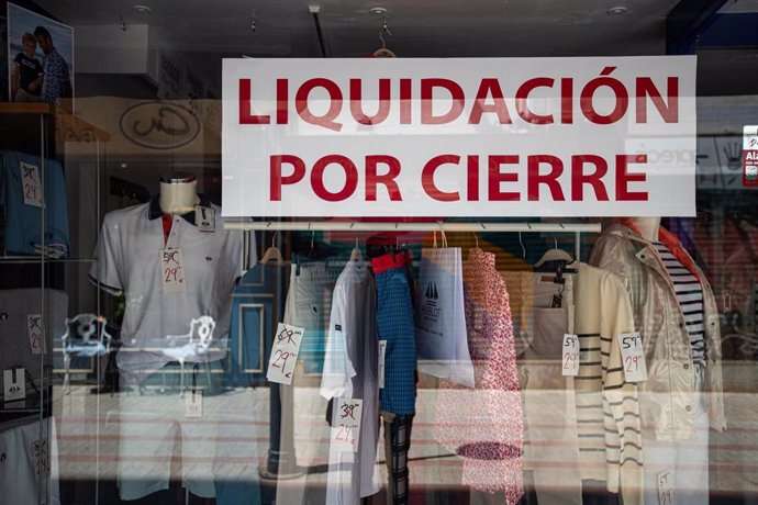 Archivo - El escaparate de un comercio anuncia 'liquidación por cierre'.