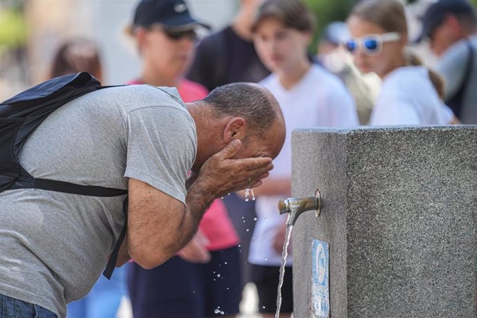 Un hombre se refresca en fuente pública. A 05 de julio de 2024, en Sevilla (Andalucía, España). 