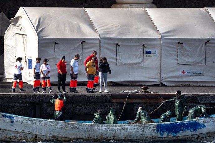 Trabajadores de la Guardia Civil, Cruz Roja y sanitarios durante la llegada de un cayuco, en el puerto de La Restinga, a 14 de agosto de 2024, en El Hierro, Santa Cruz de Tenerife, Canarias (España).