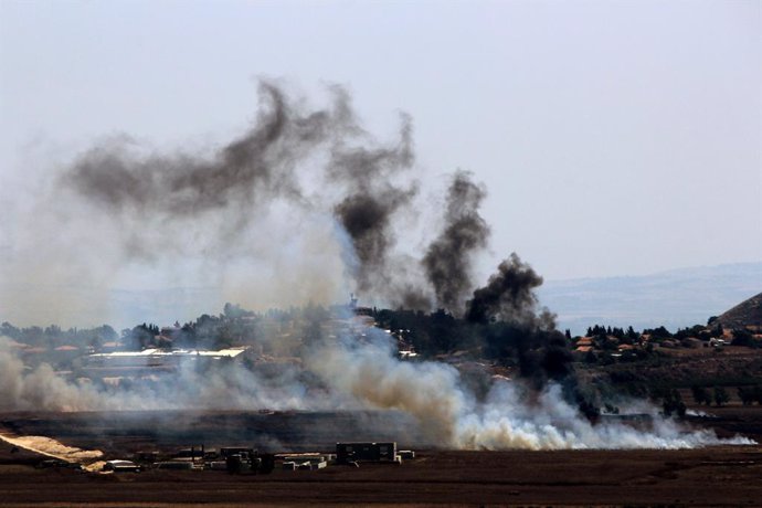 August 16, 2024, Qliyaa, Qlyiaa, Lebanon: Heavy smoke billows from Israeli shelling in open fields in Lebanon southern border village of Marjayounm where the Israeli northern settlement of Metulla is seen on the right. International diplomacy to prevent t