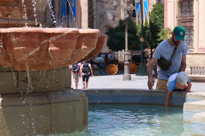 Una famlilia se refresca en una fuente para soportar las altas temperaturas. A 10 de agosto de 2024, en Sevilla (Andalucía, España). Una cuarta ola de calor afecta a todo el país desde el viernes y hasta el domingo, con temperaturas superiores a 40ºC.