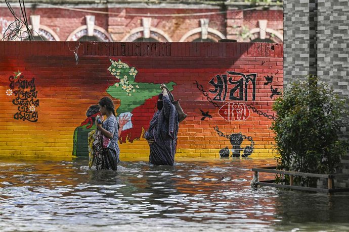 August 24, 2024, Dhaka, Bangladesh: People wade through floodwater in Feni district in Chittagong division. Flood affected area in Feni district in Chittagong division, Bangladesh.