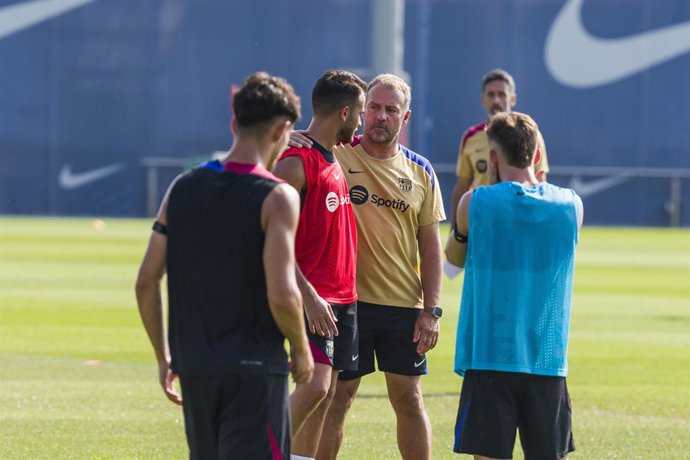 Hansi Flick, head coach of FC Barcelona, talks to Eric Garcia during a training sessions before the Spanish League, La Liga EA Sports, football match against Athletic Club de Bilbao at Ciudad Esportiva Joan Gamper on August 23, 2024 in Sant Joan Despi, Ba
