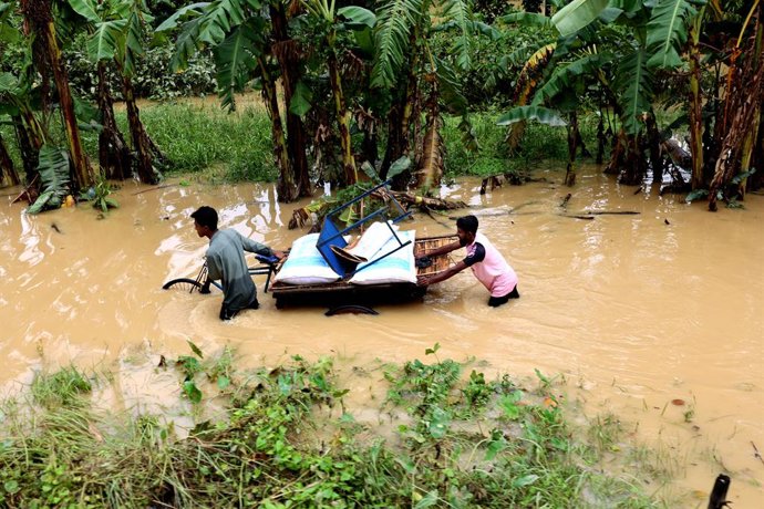 August 26, 2024, Feni, Feni, Bangladesh: Two children are being taken home in a train van collected from the flood-affected area in Fazilpur Union of Feni District, Bangladesh