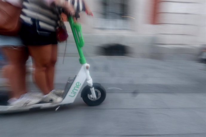 Dos personas circulan en patinete eléctrico 