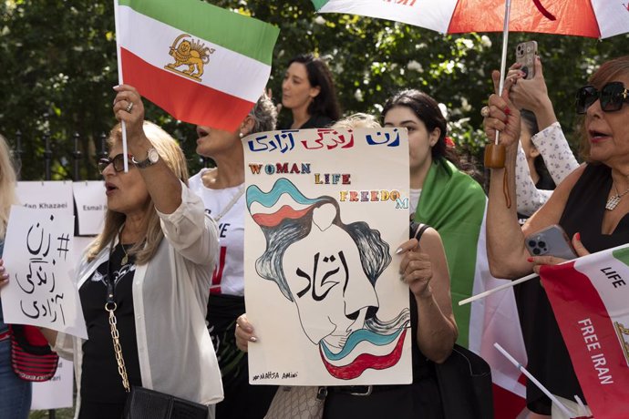 September 15, 2024, New York, New York, USA: Demonstrators chant holding Lion Sun & Sword tricolor flags and posters at City Hall Park during a vigil on Mahsa Jina Day commemorating the second anniversary of Mahsa Jina Amini's death. Woman Life Freedom NY