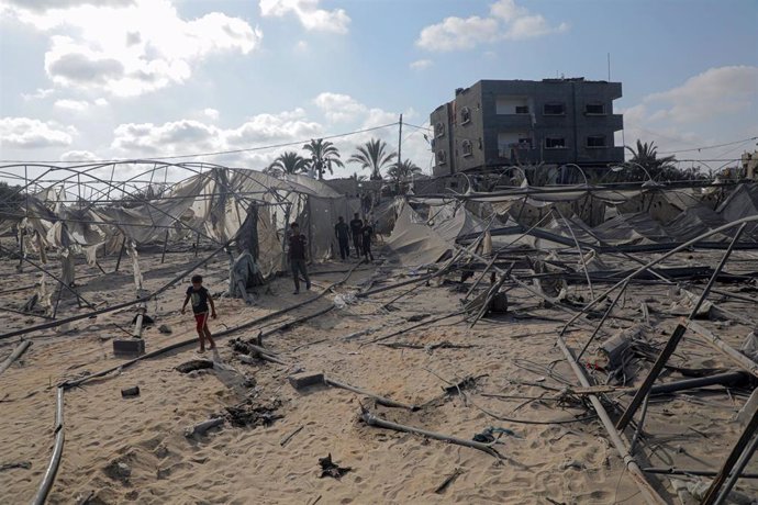 Palestinos inspeccionan un lugar bombardeado por el Ejército de Israel en la "zona humanitaria" de Al Mauasi, situada al oeste de Jan Yunis, en el sur de la Franja de Gaza (archivo)