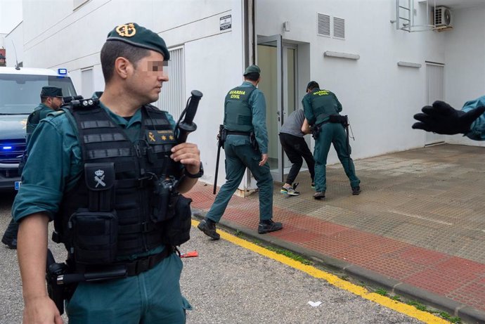 Archivo - Agentes de la Guardia Civil trasladan al juzgado a uno de los seis detenidos en febrero por la muerte de dos guardias civiles en Barbate. ARCHIVO.