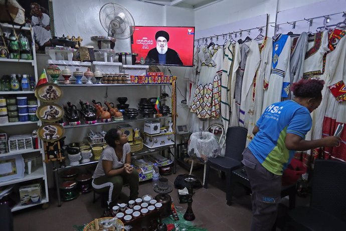 BEIRUT, Sept. 19, 2024  -- People listen to a speech by Hezbollah leader Hassan Nasrallah on screen in Beirut, Lebanon, on Sept. 19, 2024. Hezbollah leader Hassan Nasrallah said on Thursday that the explosions in Lebanon on Tuesday and Wednesday, which ta