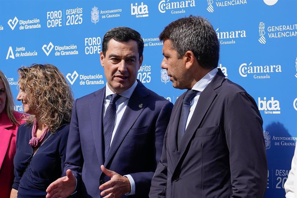 El presidente de la Junta de Andalucía, Juanma Moreno (2i), y el presidente de la Generalitat Valenciana, Carlos Mazón (d) conversan a su llegada al Foro Cope Desafíos 2025, en Granada, Andalucía (España). El presidente de la Junta de Andalucía, Juanma 