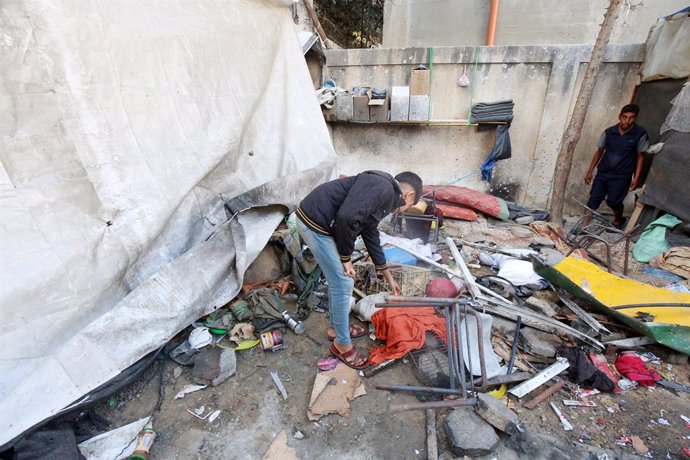 October 2, 2024, Zawaida, Gaza Strip, Palestinian Territory: Palestinians inspect the site following Israeli strikes on a tent for displaced people in a school affiliated with the United Nations Relief and Works Agency for Palestine Refugees (UNRWA), amid