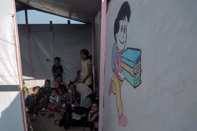 GAZA, Sept. 28, 2024  -- Palestinian students attend a class at a tent school set up inside a displacement center in the city of Deir al-Balah in the central Gaza Strip on Sept. 28, 2024.