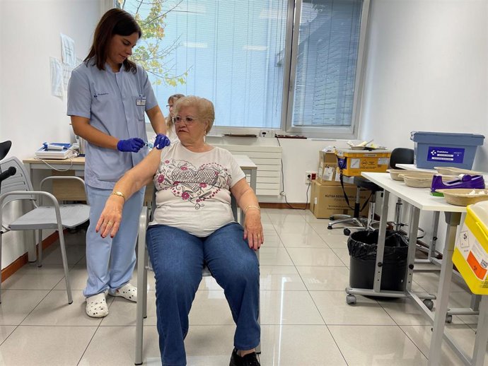 Una enfermera vacuna a una persona mayor