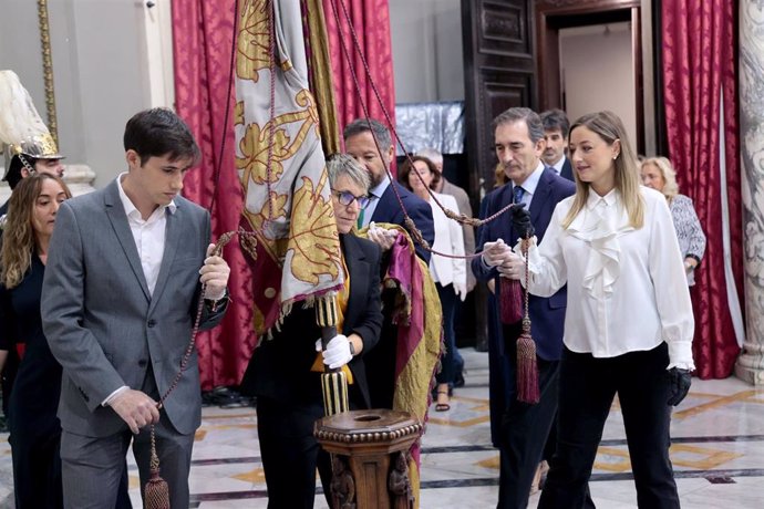 La portavoz de Compromís en el Ayuntamiento de València, Papi Robles, portando la Reial Senyera desde el Museo Histórico Municipal hasta el Salón de Cristal del consistorio.