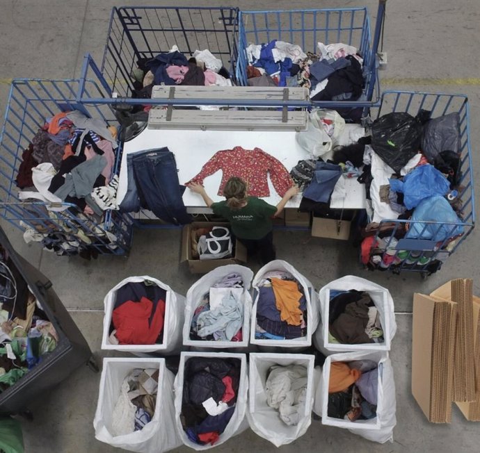 Collected second-hand clothing being sorted in a sorting centre