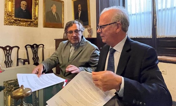 El director del Instituto de Estadística y Cartografía de Andalucía (IECA), Manuel Ignacio Castaño (i), y el hermano mayor de la Santa Caridad de Sevilla, Eduardo Ybarra (d), durante la firma.