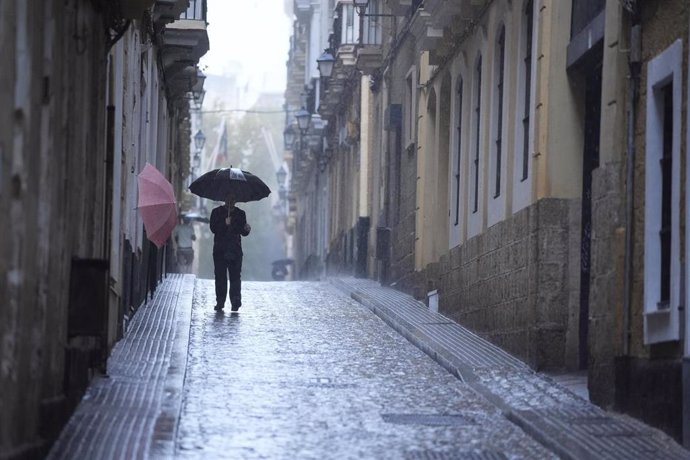 Transeuntes bajo sus paraguas durante la intensa lluvia, a 11 de octubre de 2024, en Cádiz (Andalucía, España). La Agencia Estatal de Meteorología (Aemet).