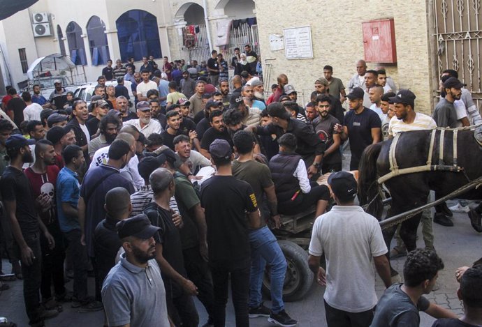 GAZA, Oct. 11, 2024  -- Palestinians transfer victims attacked by the Israeli army in the refugee camp of Jabalia, to a hospital in Gaza City, on Oct. 11, 2024. The Israeli military continues its large-scale operation in Jabalia and the surrounding area, 