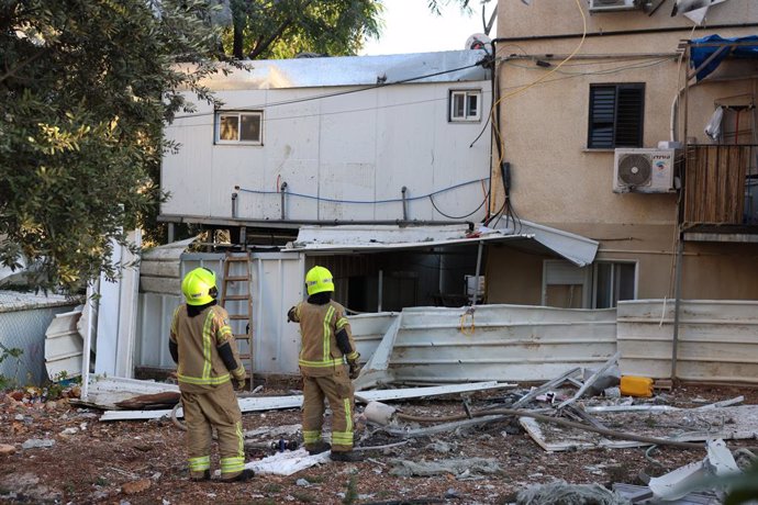 SAFED (ISRAEL), Oct. 9, 2024  -- Members of Israeli emergency services work near a building hit during a Hezbollah's rocket attack in Safed, northern Israel, on Oct. 9, 2024. Earlier on Wednesday, militants in Lebanon fired around 40 rockets at northern I