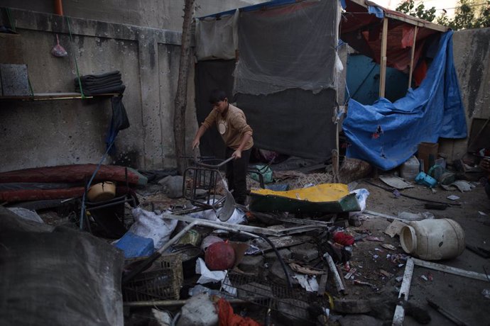 GAZA, Oct. 2, 2024  -- A Palestinian boy checks destroyed belongings after Israeli attacks at the al-Nuseirat refugee camp, central Gaza Strip, on Oct. 2, 2024. At least 67 Palestinians were killed in overnight Israeli attacks across the Gaza Strip, Pales