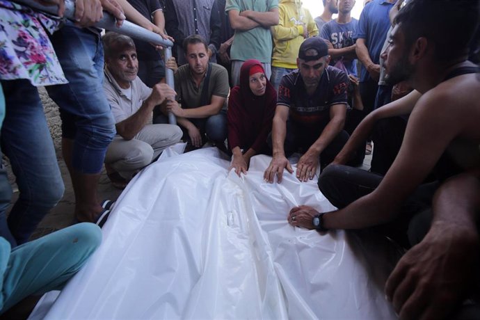 Familiares de palestinos muertos por los ataques de Israel tras su traslado a la morgue del Hospital Mártires de Al Aqsa, en la ciudad de Deir al Balá, en el centro de la Franja de Gaza (archivo)