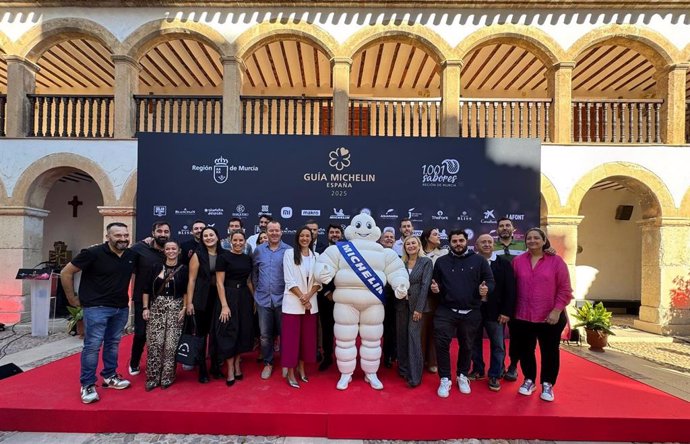 La consejera Carmen Conesa, tras el acto de presentación de la Gala Michelin, con asistentes al acto y la mascota de la marca, 'Bidendum'.