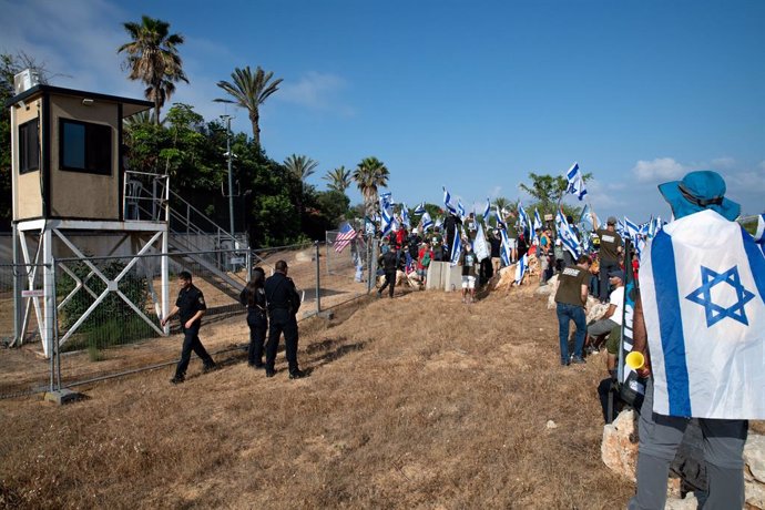 June 11, 2023, Caesarea, Israel: Israeli reservist members of the ABrothers in ArmsA gather while holding Israel flags outside the house of Prime Minister Benjamin Netanyahu during the protest against the judicial reform.