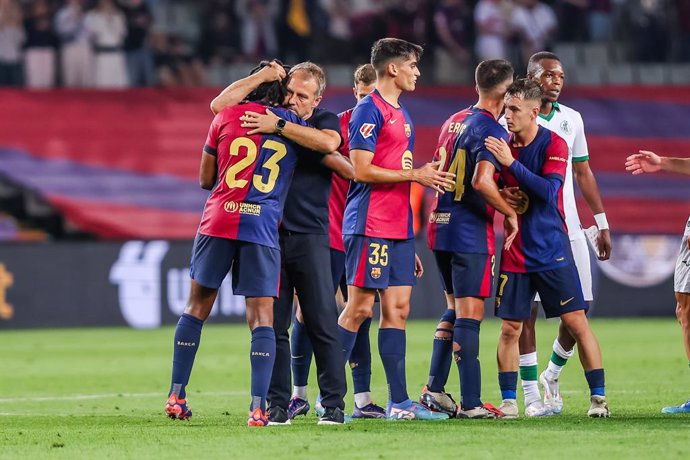 Hansi Flick, head coach of FC Barcelona, celebrates the victory with Jule Kounde during the Spanish league, La Liga EA Sports, football match played between FC Barcelona and Getafe CF at Estadio Olimpico de Montjuic on September 25, 2024 in Barcelona, Spa