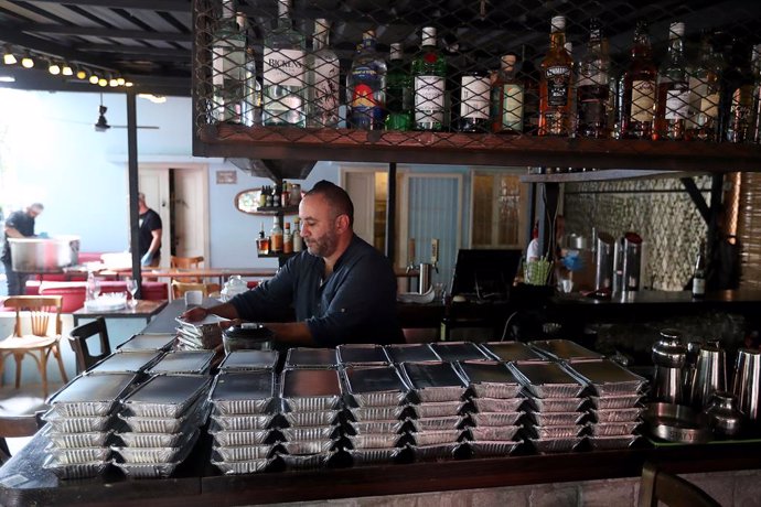 BEIRUT, Oct. 18, 2024  -- A man works at a bar turned into a kitchen for displaced people in Beirut, Lebanon, on Oct. 17, 2024. The total number of displaced persons in Lebanon due to Israeli airstrikes has risen to nearly 1.2 million, according to a repo