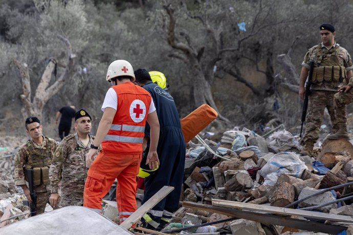 October 15, 2024, Aitou, Lebanon: A Lebanese soldier walks with Red Cross medics and others searching for people in the rubble after an Israeli attack leveled a residential building housing displaced people on October 15, 2024 in Aitou, Lebanon. The Leban