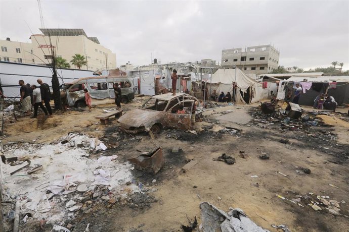 October 16, 2024, Dair El-Balah, Gaza Strip, Palestinian Territory: Palestinians sit at the site of an Israeli airstrike which hit tents for displaced people two days earlier in the courtyard of Al-Aqsa Martyrs Hospital in Deir al-Balah in the central Gaz