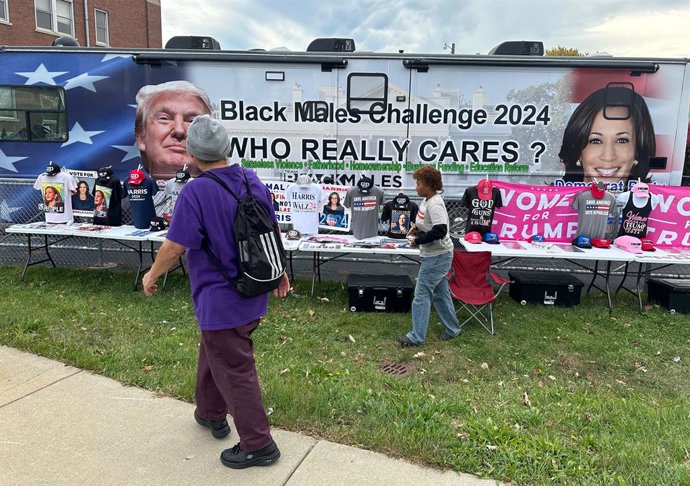 October 22, 2024, Racine, Wisconsin, USA: SACARIA FOLWER tends the "Black Males Challenge - Who Really Cares"  bus parked across from City Hall in Racine, Wisconsin Tuesday morning October 22, 2024, the first day of early voting in the state. The initiati