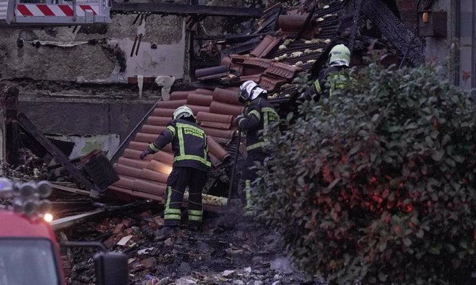 Agentes del equipo de bomberos trabaja en el edificio derrumbado