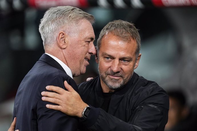 Hansi Flick, head coach of FC Barcelona, and Carlos Ancelotti, head coach of Real Madrid, gesture during the Spanish league, La Liga EA Sports, football match played between Real Madrid and FC Barcelona at Santiago Bernabeu stadium on October 26, 2024, in