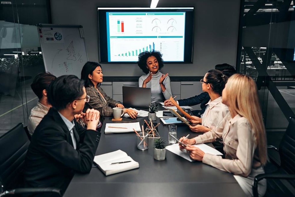 Archivo - Young confident successful business people discuss and analyze work, statistics, plans, startup in a meeting room.