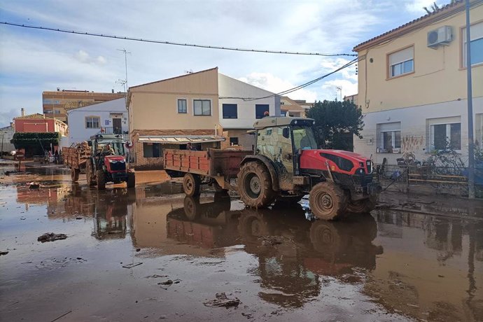 Varios tractores colaboran en la limpieza de las calles en Utiel (Valencia)