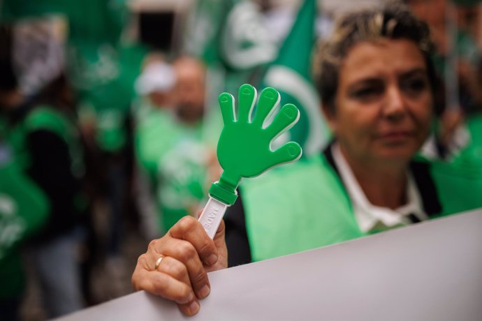 Archivo - Una mujer sujeta una pancarta durante una concentración de la Central Sindical Independiente y de Funcionarios (CSIF).