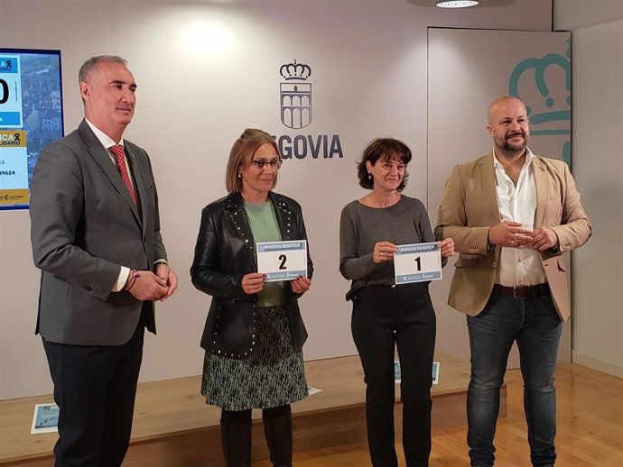 El alcalde José mazarías (izda) y el concejal de Deportes, Jesús Garrido, entregan los dorsales 1 y 2 de la marcha solidaria a la representante de Cáritas Segovia, Belén Palomar, y a la de Cruz Roja Segovia, Isabel Gómez Rincón