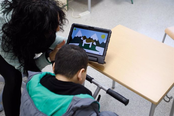 Archivo - Una docente atiende a un alumno de un centro de educación especial.