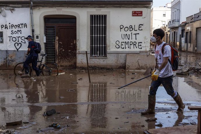 Varios voluntarios continúan la limpieza de las calles de Paiporta,  