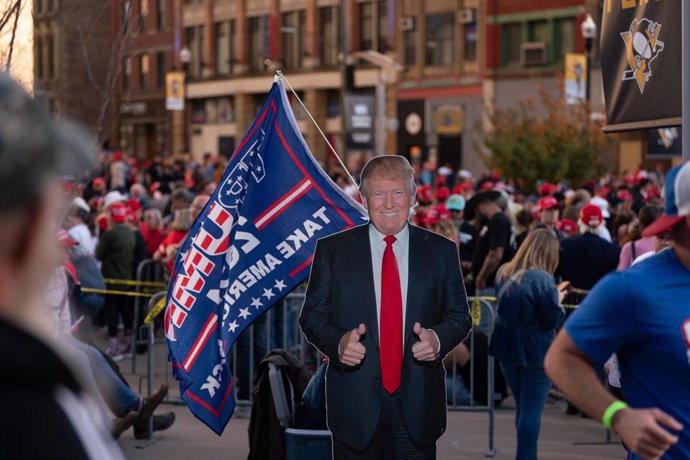 04 November 2024, US, Pittsburgh: As supporters waited, a cardboard cutout of Donald Trump was placed on the sidewalk outside the event on the last day of campaigning in the 2024 election. Supporters of Former president Trump lined up outside the PPG Pain