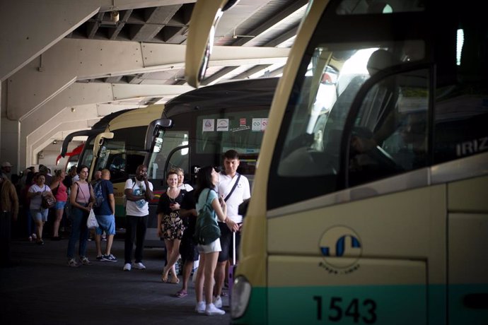 Archivo - Varias personas esperan a subir a su autobús en la estación de Autobuses de Méndez Álvaro, a 11 de agosto de 2023, en Madrid (España).