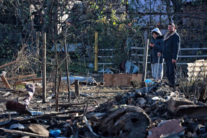 November 8, 2024, Odesa, Ukraine: ODESA, UKRAINE - NOVEMBER 8, 2024 - People stand among the debris of a damaged building after an overnight Russian drone attack in Odesa, southern Ukraine. One person was killed and nine others were wounded as a result of