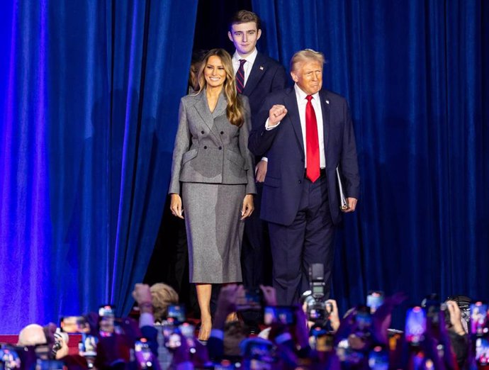 06 November 2024, US, West Palm Beach: US Republican presidential nominee and former President Donald Trump arrives to his election night party alongside his wife Melania Trump and his son Barron Trump, at the Palm Beach County Convention Center in West P