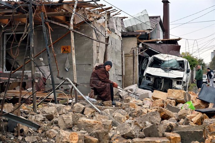 10 November 2024, Ukraine, Odesa: A woman sits on the ruins of a house destroyed by a Russian nighttime drone attack, Odesa, southern Ukraine. Photo: -/Ukrinform/dpa